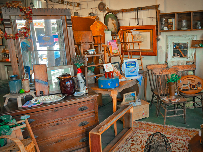 A room full of antique wooden chairs and tables