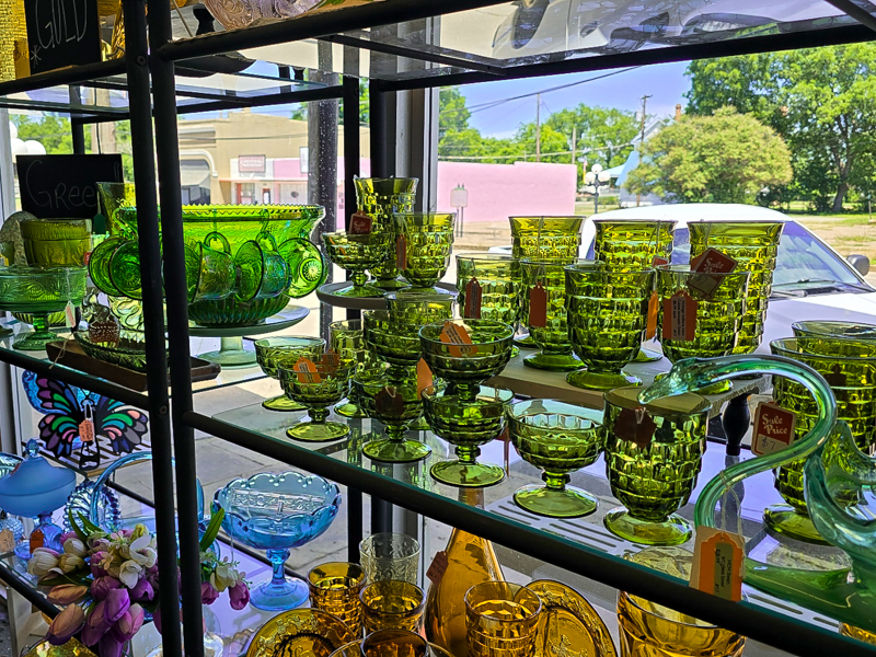 A cabinet full of green depression glass