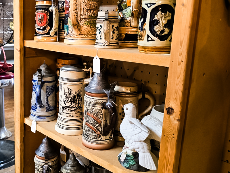 A cabinet of old beer steins