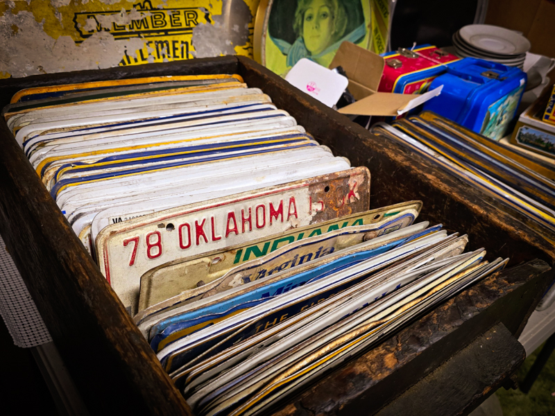 a box full of vintage license plates